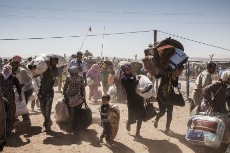 1/Syrian Kurdish refugees cross into Turkey from Syria, near the town of Kobani. The war that erupted in Syria in 2011 has propelled it into becoming the world’s single largest driver of displacement. UNHCR / I. Prickett